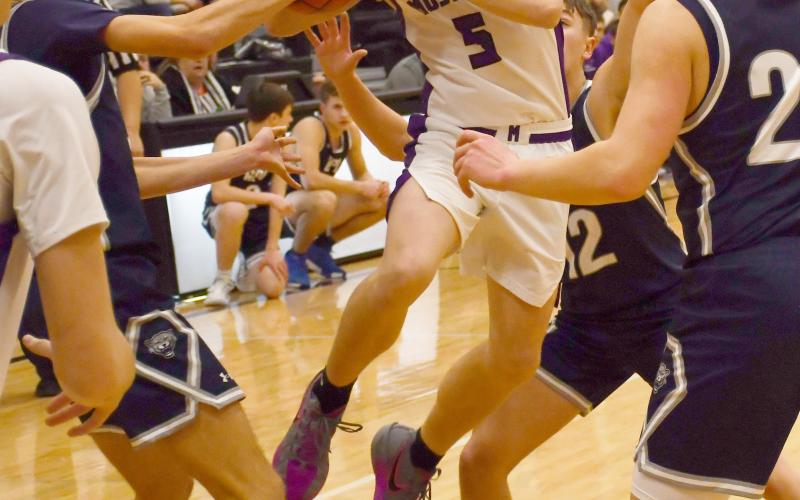 Waubay-Summit Mustangs faced off against Great Plains Lutheran Panthers Feb. 20 in Summit which ended in a 57-47 victory for the Mustangs. Here, Dylan Rumpza (5) attempts to distribute the ball while a claw of Panthers surround him. Reporter &amp;amp; Farmer | Brenner Cariveau