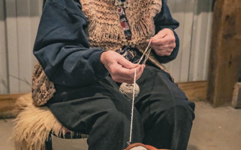 Marie McClintic of Groton turns wool thread into a two-ply yarn on her spinning wheel during the James Valley Threshing Show Sept. 6. McClintic said she got her first spinning wheel in the 1970s but had been working with wool most of her life, even passing on her hobby to her daughter and grandkids. Reporter &amp;amp; Farmer | Leyton Beardslee