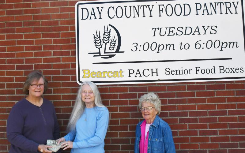 The Day County Food Pantry received a donation of funds from the first annual Chuck Aleck Memorial event. The memorial event was conducted by Bondell Raeder-Aleck Sept. 15 and saw contributions from attendees which totaled for over $1,300 in cash and giftcards. Here, on the left Margaret Kwasniewski is given the funds received from Raeder-Aleck and to the right is Carol Richardt.