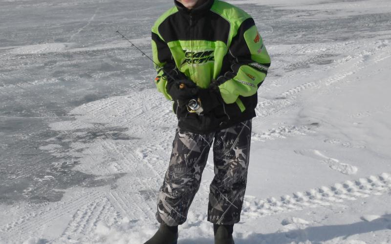 Knights of Columbus hosted the eighth annual ice fishing derby and raffle Feb. 22 at Enemy Swim Lake. Here, 11-year-old Owen Snaza from Webster attempts to catch a fish from an ice hole during the derby. Owen was accompanied by his father Nick Snaza.