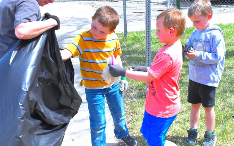 Earth Day was April 22 and Webster Area Elementary School honored this day by going outside to clean up dirty areas near the school. From left, Ridge Neuberger, Xavier Wegleitner and Garrett Curran help clean up the back of the school and help save the world one piece of trash at a time. Reporter &amp;amp; Farmer | Connor Handrahan