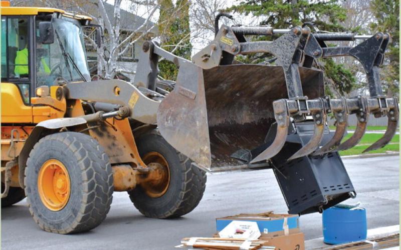 Webster’s annual city wide clean up started April 27. A city crew passed every street and picked up any trash left by residents. Here, John VanBeek operates a loader to pick up a pile of items left on the curb at W. 7th Ave. April 28. Reporter &amp;amp; Farmer | Connor Handrahan
