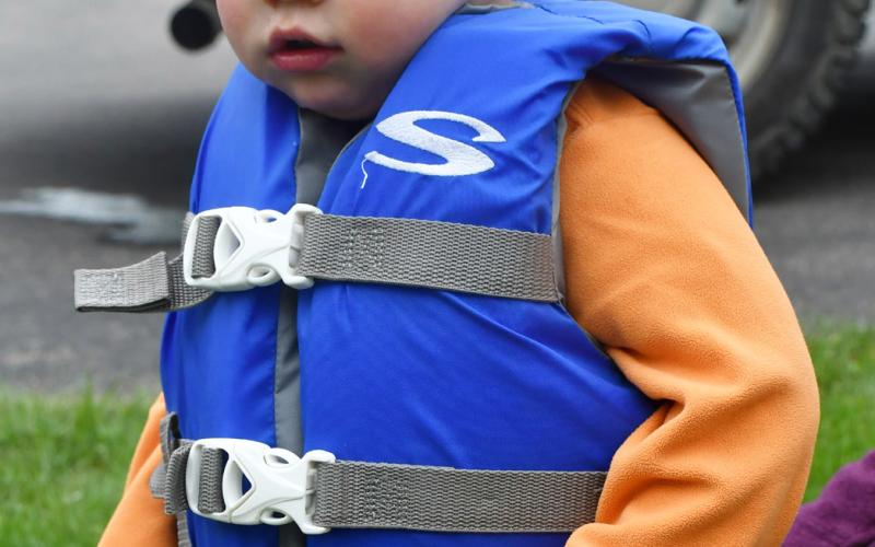 (At Right) Elliot Mellgren son of Olivia Mellgren stands with a life jacket on during the Thrivent safety event June 25. Reporter &amp;amp; Farmer | Annie Witt