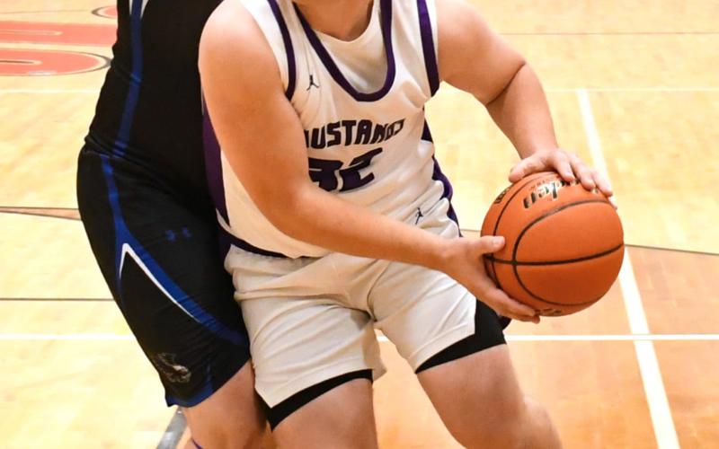 Tripp Gaikowski (32) of Waubay/Summit evades a defender during the Mustangs 63-35 win against Florence/ Henry Falcons Dec. 15 in Summit. Gaikowski aided the Mustangs with two points in the victory. Reporter &amp;amp; Farmer | Robert Dulitz