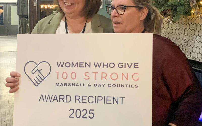 Jennifer Roerig presents the top 100 Strong of Marshall and Day counties award to Marie Marlow of the Marshall County Food Pantry during the first annual Women Who Give event Dec. 2 held in Webster. Five non-profits were in the running for the top prize, this year equating to $9,000. Each of the other four charities received $925. In total, the event saw 117 women register and raised $12,700. See more: 14. Reporter &amp;amp; Farmer | Amanda Dulitz