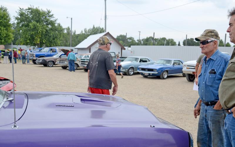During the Day County Fair Aug. 10, numerous classic cars were on display for the public to view. Here, Roger Pesall and Carl Pulvermacher look at and talk about a classic Dodge Dart 383 Magnum as others walk around in the background. Reporter &amp;amp; Farmer | Amanda Dulitz