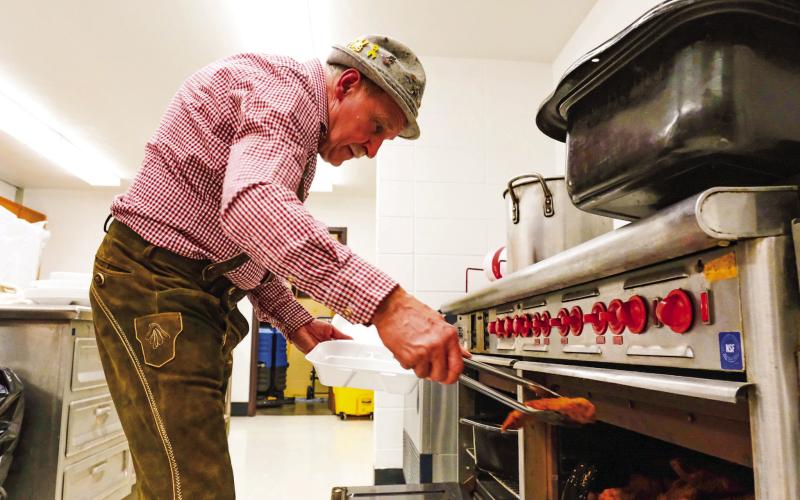 Webster Mayor Mike Grosek takes some schnitzel out of the oven for the traditional German meal served during Germanfest at Webster Armory Sept. 27 (see more on page 14). Reporter &amp;amp; Farmer | Leyton Beardslee
