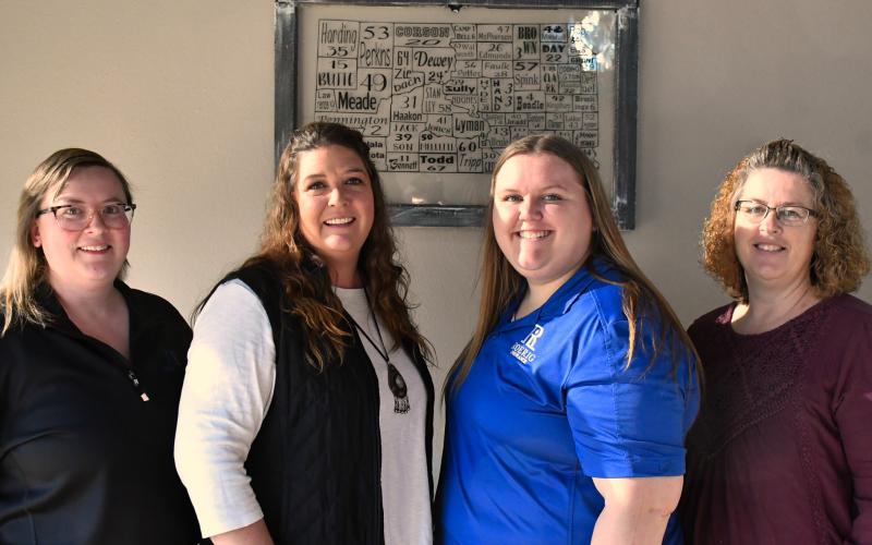 Standing in the Roerig Insurance office lobby are Webster team members Brooke Smidt, Katy Marx, Kayla Kirchmeier, Amy Fischer.
