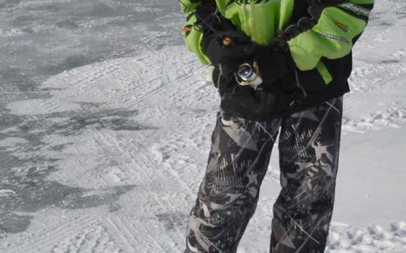 Knights of Columbus hosted the eighth annual ice fishing derby and raffle Feb. 22 at Enemy Swim Lake. Here, 11-year-old Owen Snaza from Webster attempts to catch a fish from an ice hole during the derby. Owen was accompanied by his father Nick Snaza. Reporter &amp;amp; Farmer | Brenner Cariveau
