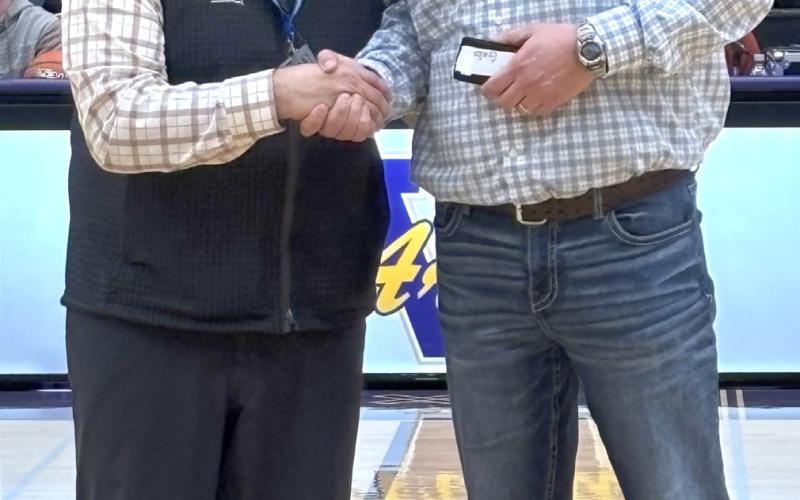 Webster Area third grade teacher and former basketball coach Jared Vergeldt, right, receives his 25 year coaching award from SDHSAA executive director Dan Swartos during halftime of a State A girls basketball tournament game in Watertown March 13. Vergeldt began coaching for the Bearcats in 1997 and spent time coaching boys and girls basketball, track, cross country and volleyball. Reporter &amp;amp; Farmer | Subscriber snapshot