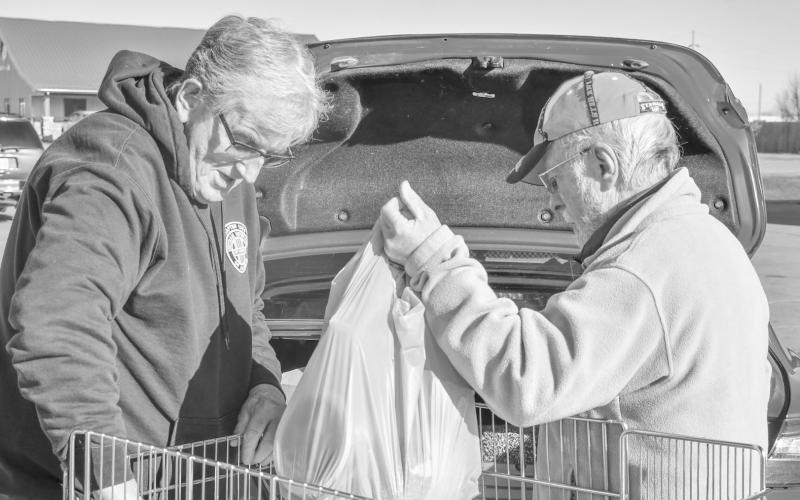 Watertown VVA Chapter 1054 president Jerry Denman, left, helps veteran Bob Dolney of Bristol load up groceries at Mike’s Jack &amp;amp; Jill in Webster Nov. 24 during the VVA’s veteran holiday meal give-away. The VVA will be organizing a second holiday meal give-away for Day County Veterans at the same location from 10 a.m. to 2 p.m. Dec. 22. Reporter &amp;amp; Farmer | Leyton Beardslee