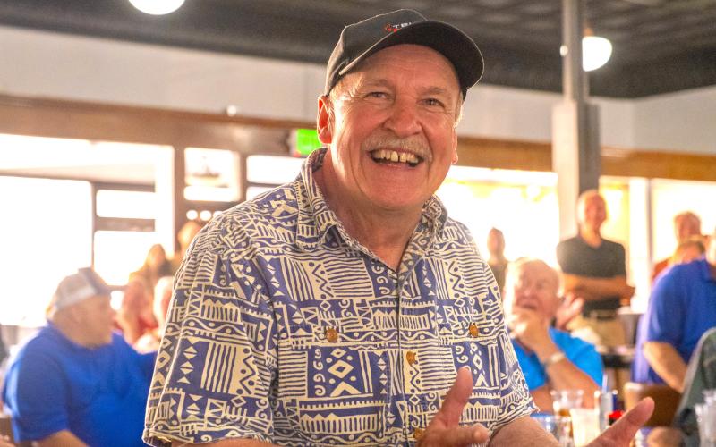Webster Mayor Mike Grosek watches a birthday video, sent by some of his friends from Germany, during his surprise 70th birthday celebration in Webster Aug 16. Roots owner Dale Miller estimated 250-300 people attended the celebration which also gave ode to Grosek’s 40th year as mayor. Reporter &amp;amp; Farmer | Leyton Beardslee