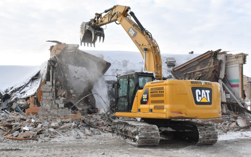 An excavator demolishes the 1950s wing of Webster Area High School Dec. 2. The demolition comes after the school’s insurance company pressured the school with a non-renewal notice to either fix or demolish the wing because of structural concerns. Reporter &amp;amp; Farmer | Leyton Beardslee