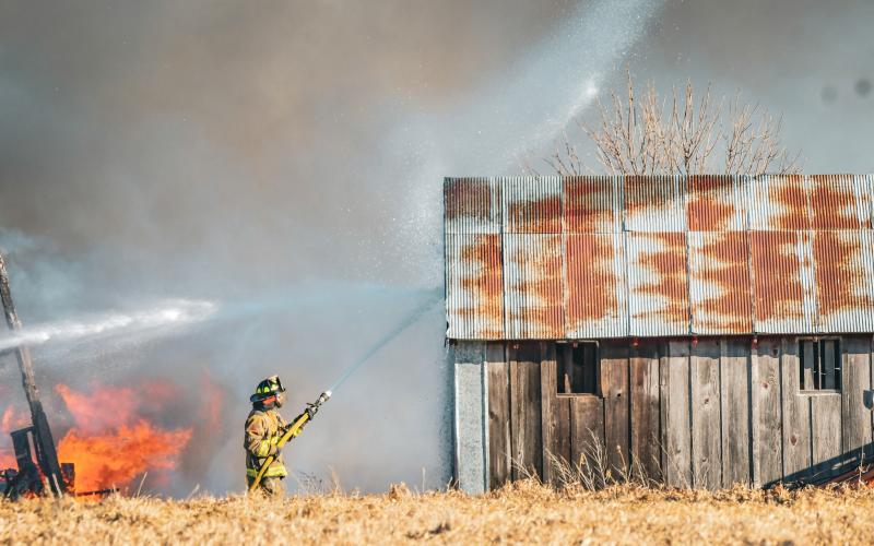 Second assistant fire chief Chris Gravley of Webster Fire Department sprays down a building to keep flames from spreading after a barn fire broke out at 14308 423rd Ave. south of Bristol Jan. 15. Additional details about the fire will be available in next week’s issue. Reporter &amp;amp; Farmer | Leyton Beardslee