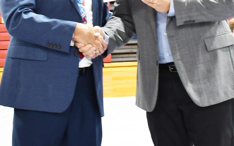 As a Veterans Day celebration was held Nov. 11 at Webster Armory, numerous events took place including choirs, essays and a military ceremony. Here Webster Area School Superintendent Jim Block left shakes hands with Jeff Nelson, Day County Veterans Service Officer after presenting a check worth $700 as the Veterans Day event ended. Reporter &amp;amp; Farmer | Brenner Cariveau