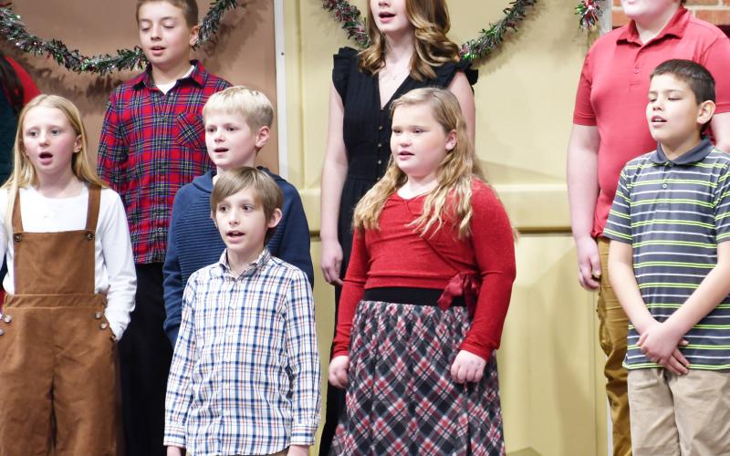 Webster Area elementary students k-6 participated in the winter concert Dec. 9 at the Webster Armory. Here, in back from left, fourth grade students, Gunnar Lesnar, Izzy Treece, Graysen Dean; in middle row from left, Kori Gaikowski, Grant Sinner, Emerie Schlechter, Matthew Sichmeller and in front Luke Sichmeller find their vocal range during the performance. Reporter &amp;amp; Farmer | Brenner Cariveau