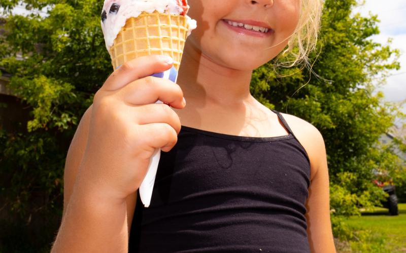 Naomi Lesnar, age eight, daughter of Marlaina and Christopher Kinn from Grenville holds up her ice cream cone July 19 at Waubay Fun Fest. The festival ran July 18-20 and included events such as a cornhole tournament, live music and a parade. Reporter &amp; Farmer | Leyton Beardslee