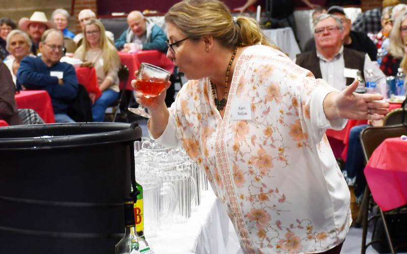 The third annual Day County Veterans Banquet was held at the Webster Armory Nov. 9. One of the events of the night was the annual grog bowl ceremony which sees a variety of unorthodx ingredients added to make a punch. Here, Kari Nelson attempts to drink the first batch of the grog bowl. Reporter &amp;amp; Farmer | Brenner Cariveau