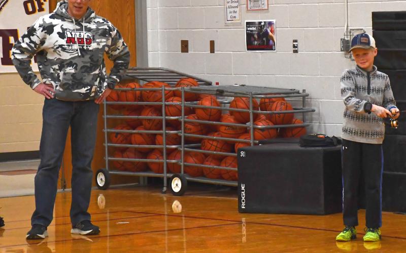 Neenah High School hosted a fishing learning day at Webster Area Elementary and Middle School Feb. 26, where students were taught fishing techniques. From left, David Sonnabend and right, Matthew SIchmeller practice casting their fishing rods. Students took turns using the fishing rod and tried to catch the plastic fish. Reporter &amp;amp; Farmer | Connor Handrahan