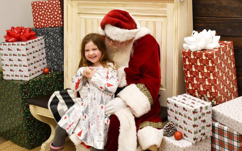 Santa visited the Brewhouse Dec. 21 as part of a fundraising event in a competition with the Grinch. Here, five-year-old Alena Carlson from Webster smiles as Santa asks for her Christmas wishes. Alena asked Santa for Barbie dolls. Alena is the daughter of Abbie Carlson and Justin Carlson. Reporter &amp;amp; Farmer | Brenner Cariveau