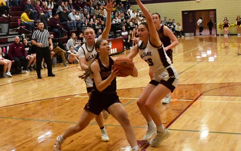 Webster Area girls basketball traveled to Milbank to face the Bulldogs in a first round matchup in the 1A regional bracket which Webster Area lost 28-63. Here, Chloe Mammenga (5) atempts to drive past Milbank defenders Isabella Anderson (5) and Claire Snaza (20). Reporter &amp;amp; Farmer | Brenner Cariveau