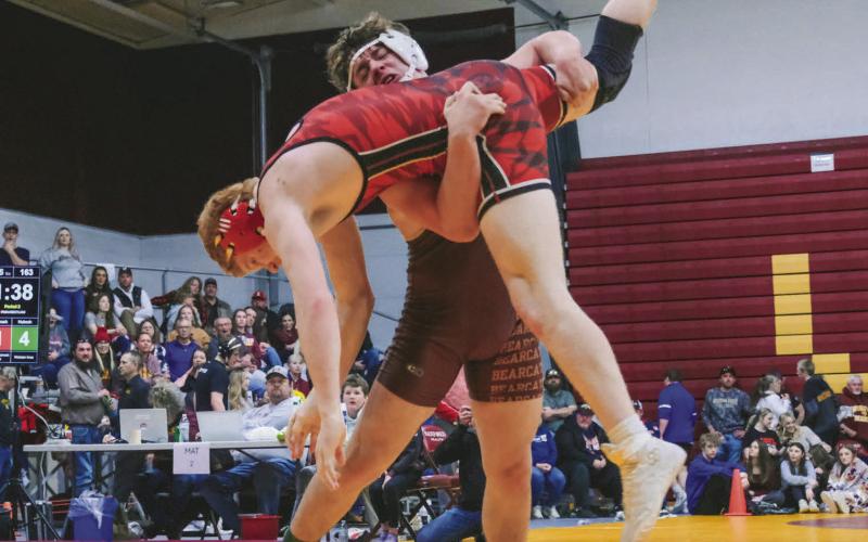 Nathan Hubsch of Webster Area Bearcats picks up Hayden Landmark of Deuel/Deubrook Area Cardinals during their match at SDHSAA Region 1B boys tournament Feb. 21 in Webster. Hubsch won the match by fall in 2:26 and went on to place fourth in the 175 weight class. Reporter &amp;amp; Farmer | Leyton Beardslee