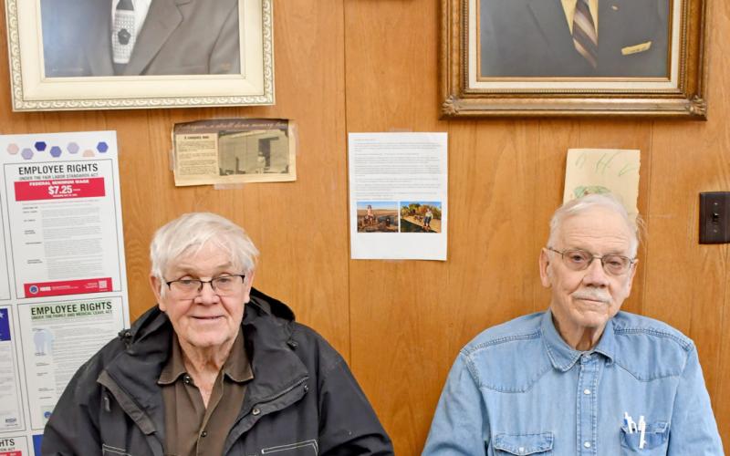 Hansmeier brothers Keith and Floyd sit beneath portraits of their grandfather Henry and father Ralph in the office of Hansmeier &amp;amp; Son, Inc. in Bristol.