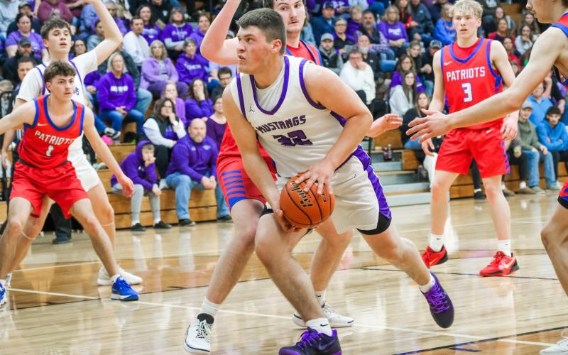 Tripp Gaikowski of Waubay/Summit Mustangs drives towards the hoop through defenders during their 51-36 victory over Hitchcock-Tulare Patriots in the Region 1B quarterfinals March 3 in Waubay. Gaikowski totaled six points in the win and the Mustangs advanced to take on Leola/Frederick Titans March 6 which was not completed in time for results to be published. Reporter &amp;amp; Farmer | Leyton Beardslee