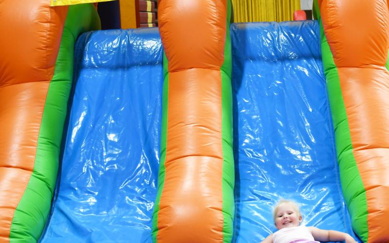 As Germanfest was celebrated Sept. 28, attendees inside the armory could purchase items from vendors, get drinks, and food The children had two different bouncy houses to play on. Here, three-year-old Webster native Lucy Spears, slides down one of the bouncy house slides with her mother Megan watching in the background. Reporter &amp;amp; Farmer | Brenner Cariveau