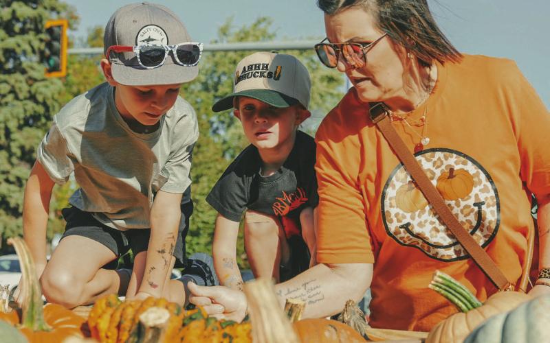From left, Holden Martin, seven, Layton Martin, three and their grandmother Patti Martin, Webster, pick out pumpkins during Pumpkin Fest in Webster Oct. 4. This year marked the 26th anniversary for the annual festival. Reporter &amp;amp; Farmer | Leyton Beardslee