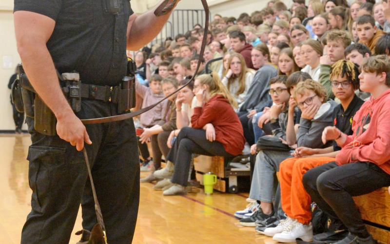Members of the South Dakota Highway Patrol were at Webster Area High School April 23 to answer questions and hold a demonstration of the drug sniffing dog named Murph, a six-year-old Belgian Malinois. Here, handler Trooper Brandon Miller stands before the assembly of youth answering questions related to his line of work. Both Miller and Murph are from Webster. Reporter &amp;amp; Farmer | Amanda Dulitz
