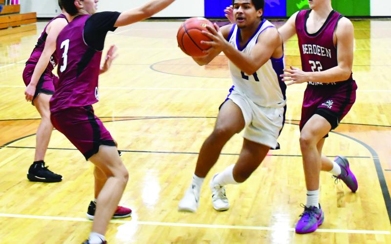 Waubay-Summit hosted Aberdeen Christian Knights Jan. 23 in a contest the Mustangs won 43-41. Here, Traveion Neilan (24) drives to the basket through Aberdeen Christian defenders Luke Kaiser (3) and Grady Jett (22). Reporter &amp;amp; Farmer | Brenner Cariveau
