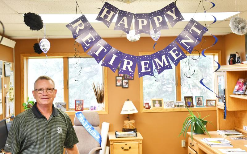Lake Region Electric manager Tim McIntyre stands next to his decorated office which celebrates his upcoming retirement Sept. 3. Reporter &amp;amp; Farmer | Brenner Cariveau