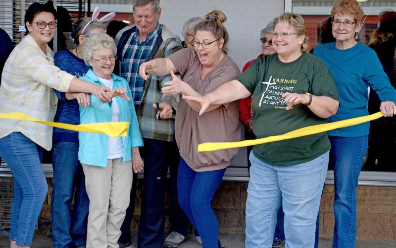Melanie Gaikowski, Charlene Schlotte, Carol Richardt, Howard Hvidsten, Elaine Bistodeau, Needs Anonymous Director Kari Nelson, Mary Lindquist, Cathy Witzke and Anita Reiprich were among the volunteers on hand for a ribbon cutting ceremony April 12 during the Needs Anonymous grand re-opening event. See more, page 15. Reporter &amp;amp; Farmer | Amanda Dulitz