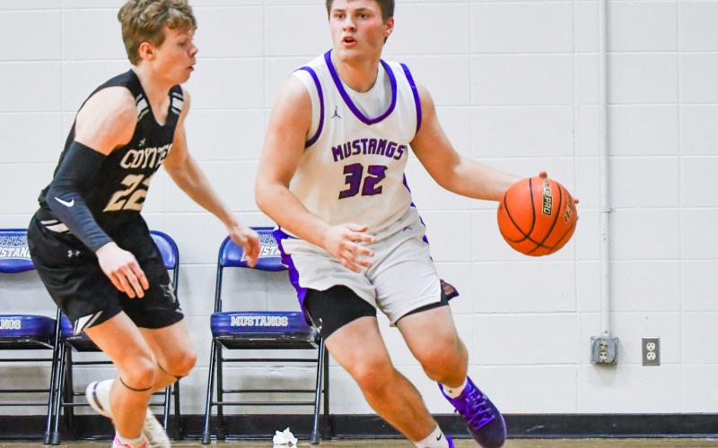 Tripp Gaikowski (32) of Waubay/Summit drives past a defender during the Mustang’s 66-49 win over Waverly-South Shore Coyotes Feb. 13 in Waubay. Gaikowski aided his team with four points in the victory. Reporter &amp;amp; Farmer | Leyton Beardslee