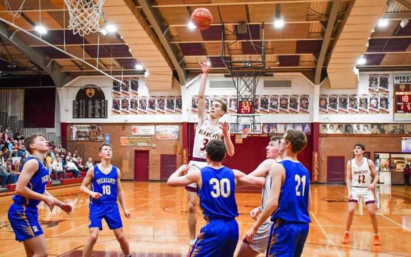 Seth Lesnar of Webster Area floats a shot over Redfield Pheasant defenders during the Bearcats 85-64 Region 1A playoff victory March 3 in Webster. The win was the Bearcats first regional playoff victory in 22 years spanning back to 2004. Reporter &amp;amp; Farmer | Connor Handrahan