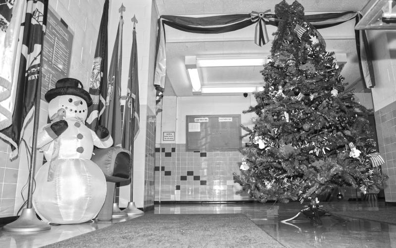 At the Day County Courthouse main entrance guests are greeted by Frosty and an American themed Christmas tree. The courthouse is filled with more themed trees decorated by organizations and businesses and on display until Jan. 5. Reporter &amp;amp; Farmer | Connor Handrahan