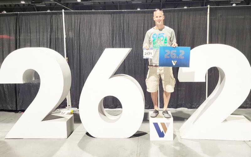 Waubay resident Curtis Huffman competed in the Las Vegas marathon Nov. 3 in Las Vegas, NV. Huffman said the conditions were extremely difficult at the start of the race with high winds and cold temperatures. Here, Huffman poses with his competition number in his right hand and a sign which displays the number of miles in a marathon while simultaneously standing on a larger display with the same figure. Reporter &amp;amp; Farmer | Subscriber Snapshot