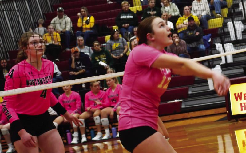 Webster Area Bearcats volleyball faced off against Northwestern Wildcats Oct. 14. Here, Karli Sannes (12) attempts to hit the ball to set up a play for her teammates as Northwestern player Ashley Haven (4) watches in anticipation. Ultimately, the Bearcats lost in three sets. Reporter &amp;amp; Farmer | Brenner Cariveau