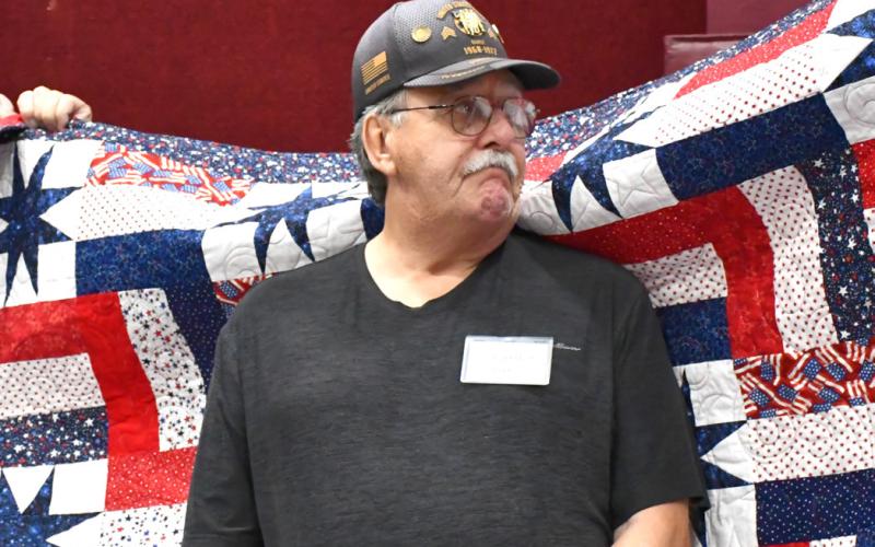 Carlton Barse receives his Quilt of Valor during the annual veterans banquet at Webster Armory Nov. 8. Barse served as a Sergeant in the United States Army from 1969-72 and his awards include Purple Heart, Combat Infantry Badge, Vietnam Service Medal, Vietnam Campaign Medal. Reporter &amp;amp; Farmer | Leyton Beardslee