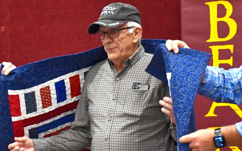 Dennis Lewandowski receives his Quilt of Valor during the annual veterans banquet at Webster Armory Nov. 8. Lewandowski served as Specialist 4th Class in the United States Army from 1968-70 and his awards include Vietnam Service Medal and Vietnam Campaign Medal. Reporter &amp;amp; Farmer | Leyton Beardslee