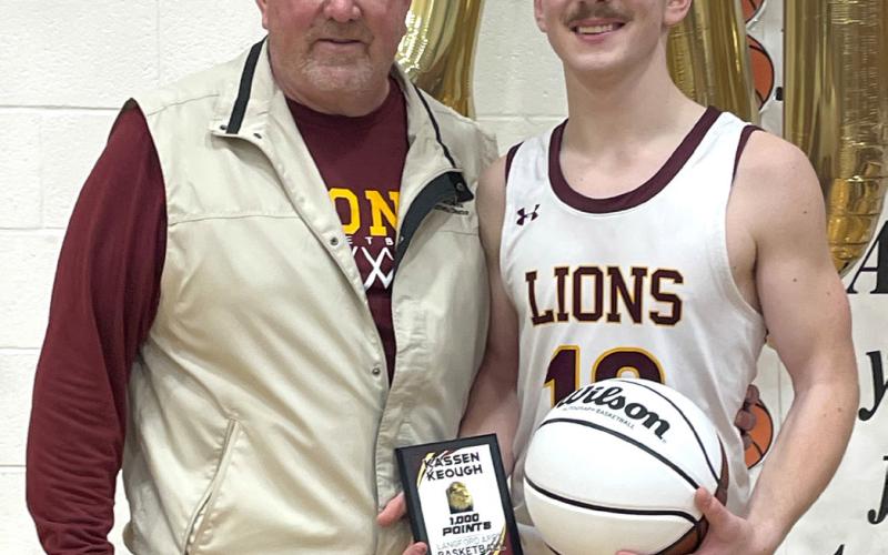 Langford Area senior Kassen Keough holds a plaque memorializing his 1,000th varsity basketball point, standing next to head basketball coach Brian Schuring following their game against Wilmot Wolves in Langford Jan. 3. Reporter &amp;amp; Farmer | Subscriber snapshot