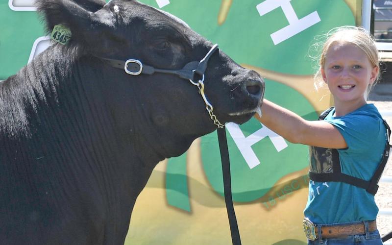 Posing with her reserve grand champion market beef is Kori Gaikowski during the Day County Fair Aug. 9. Reporter &amp;amp; Farmer | Amanda Dulitz