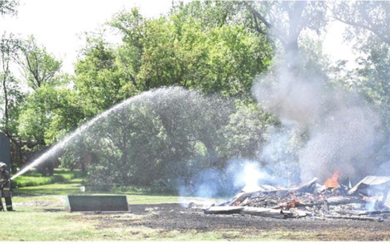 A shed started on fire near 439th Ave. east of Webster May 28. Waubay and Webster Fire Departments were called to scene. No report was available as of press deadline. Here, Webster fire fighter Leonard Deibert takes action to help put out the flames. Reporter &amp;amp; Farmer | Connor Handrahan