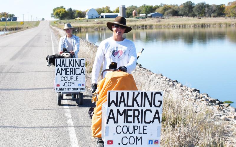 Torin and Paige Rouse walk with their dog Jak in their 12,000 mile journey which would result in them walking across every state. Here, the Rouse family walks just outside of Webster Oct. 7 as they prepared to finish up their trip in Watertown. Reporter &amp;amp; Farmer | Brenner Cariveau