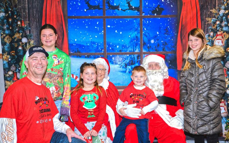 Santa and Mrs. Claus greet and take pictures with families at Waubay Senior Center Christmas celebration Dec. 6. From left, Dave, Aliyah, Abigail, Trenton and Kallie Zirbel get asked by Santa and Mrs. Claus if they’ve been good this year and what type of gifts they want for Christmas. Reporter &amp;amp; Farmer | Connor Handrahan