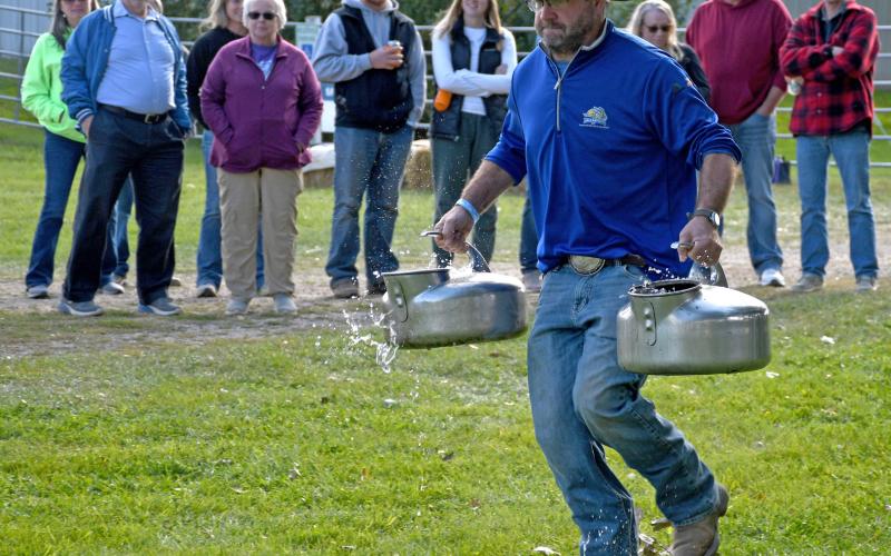 Sam Hubsch races with a pair of milk pails in the Fittest Farmer contest at the first annual Harvest Bash Sept. 6 where contestants were pitted against not only each other but also against various obstacles. Reporter &amp;amp; Farmer | Amanda Dulitz