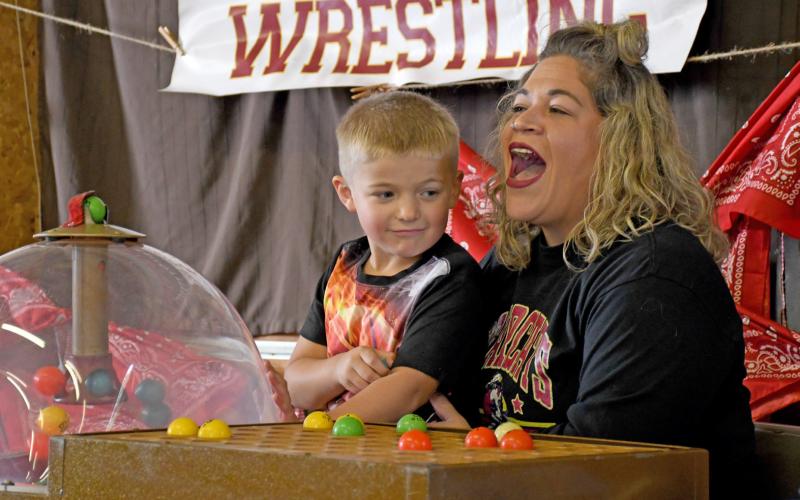 Six-year-old River Marko sits on his mom, Kristen Marko’s lap to help draw numbers to call for bingo Sept. 6 during the first annual Harvest Bash. Reporter &amp;amp; Farmer | Amanda Dulitz
