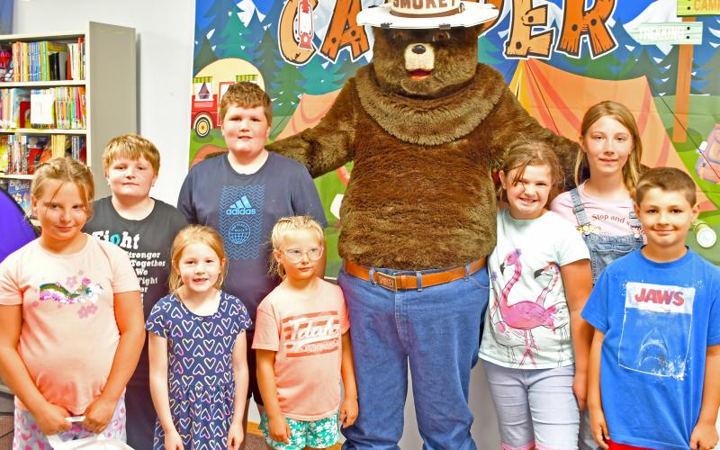 Webster Area Public Library celebrated the 80th birthday of Smokey the Bear July 12. Since 1944 Smokey the Bear has been the symbol of protection for America’s forests and grasslands from human-caused wildfires. Pictured are those who helped celebrate the occasion, from left front Freyja Howe, Addy Johnson, Beatrix Howe, Gracelyn and Archer Chevalier. Back row includes Corbin and Bryson Johnson and Iris Marsh. Reporter &amp;amp; Farmer | Annie Witt