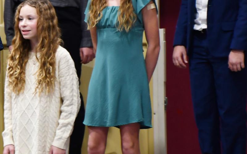 Webster Area students k-6 performed at the winter concert event Dec. 9 at the Webster Armory. Here, sixth graders left in back Kailani Andrade and Harrison Wagner; in middle row Portlyn Johnson and in front Embry Duenwald sing holiday songs. Reporter &amp;amp; Farmer | Brenner Cariveau